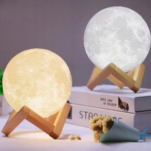 a moon shaped lamp on a book