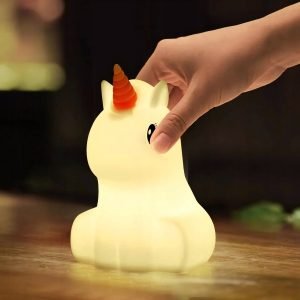 a hand touching a light up unicorn