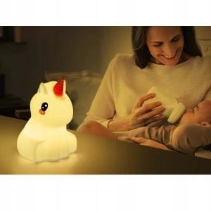 a woman feeding a baby