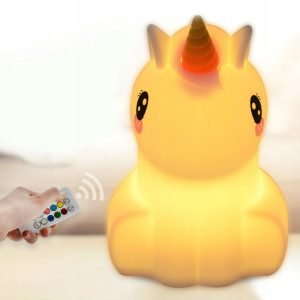 a hand holding a remote control to a light up toy unicorn
